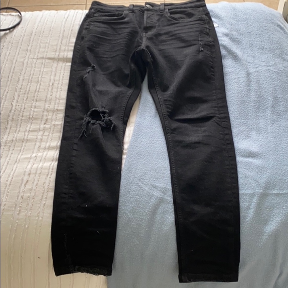 Black, slightly ripped jeans.